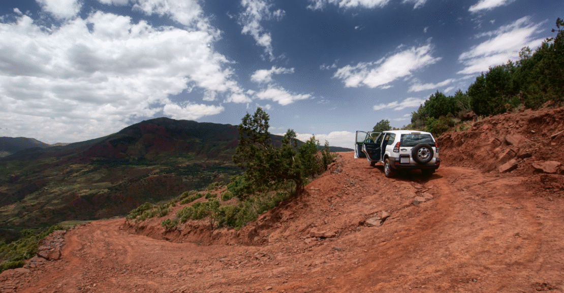Rental car parked in scenic Moroccan landscape during a road trip adventure