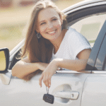 Smiling woman enjoying a scenic road trip in Morocco inside a rental car
