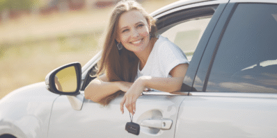 Smiling woman enjoying a scenic road trip in Morocco inside a rental car